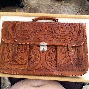 Western leather 2 pocket portfolio bag with Indian on Back. Will fit a laptop.